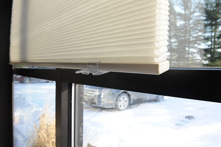 Close-up of pleated honeycomb cellular blinds on a window