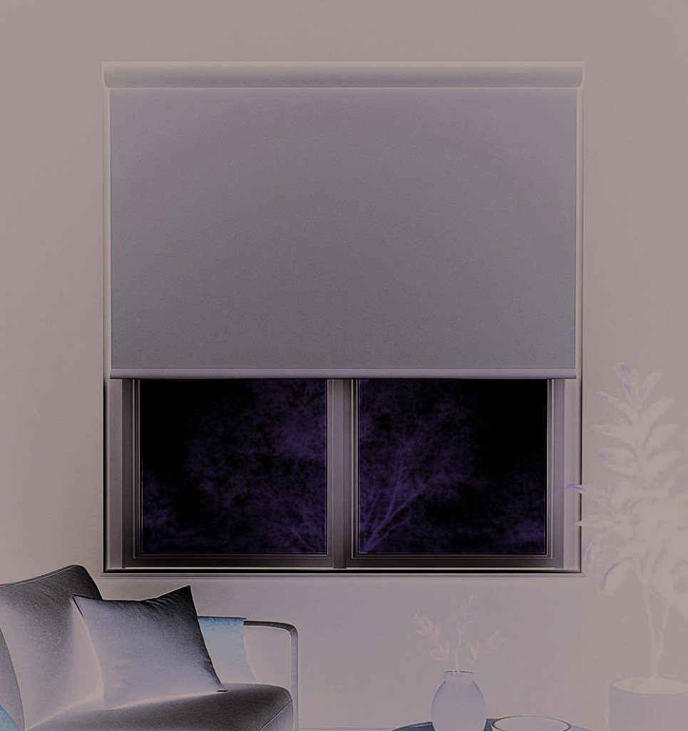 Roller blind covering a living-room window at dusk